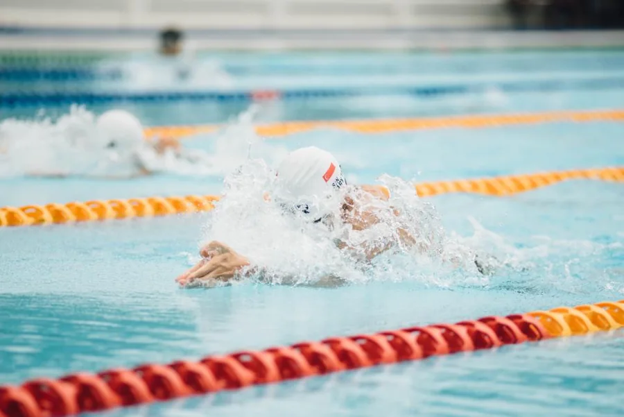 A swimmer training in a marked pool lane